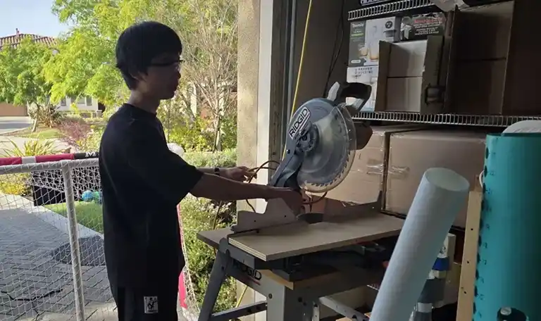 Me in Chris's garage next to a miter saw